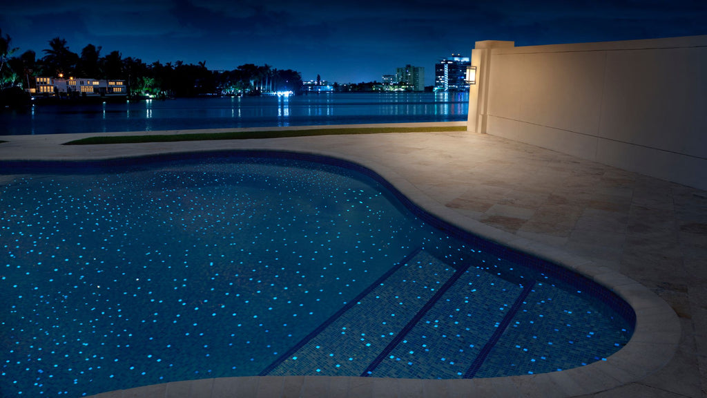 Glow in the dark glass tile from the fireglass series used in a pool to mimic the stars in the sky.