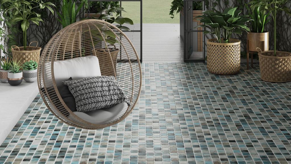 Beautiful tile from the nature collection being used in a patio floor. There is a hanging swing chair hanging over it and tropical plants in the background.