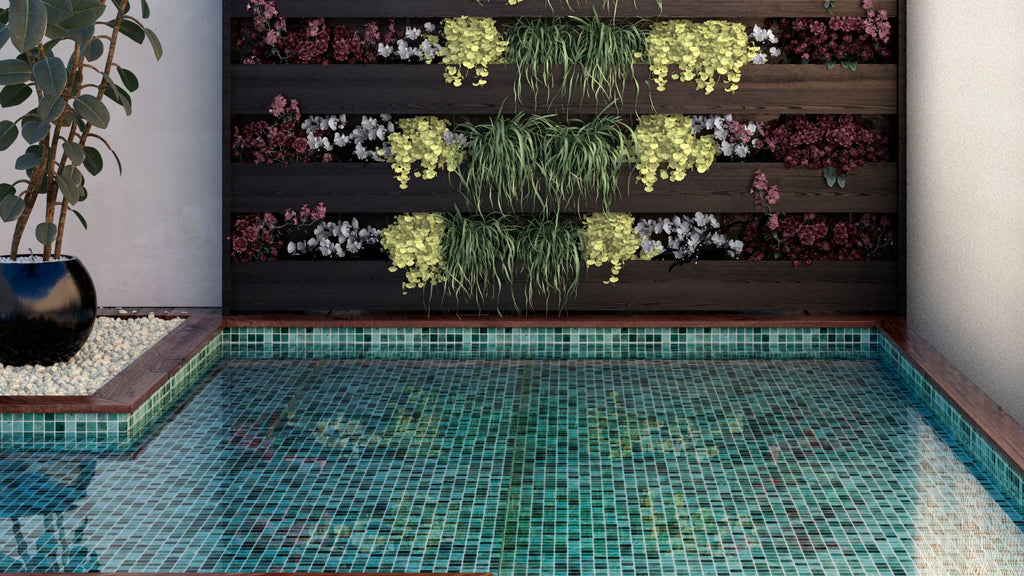 Beautiful green tile from the Nature collection installed in a tropical looking pool as an all-glass tile pool finish.