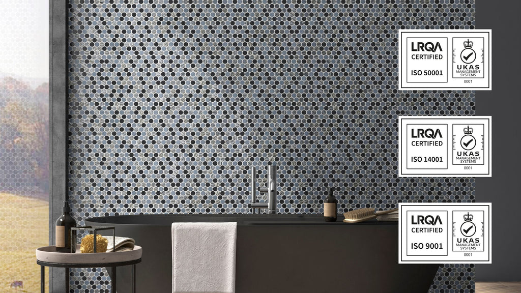 Mixed hexagon tile in a bathroom feature wall. The image is overlaid with 3 graphics showcasing Vidrepur's certifications. These include ISO 9001, ISO 14001, and ISO 50001.