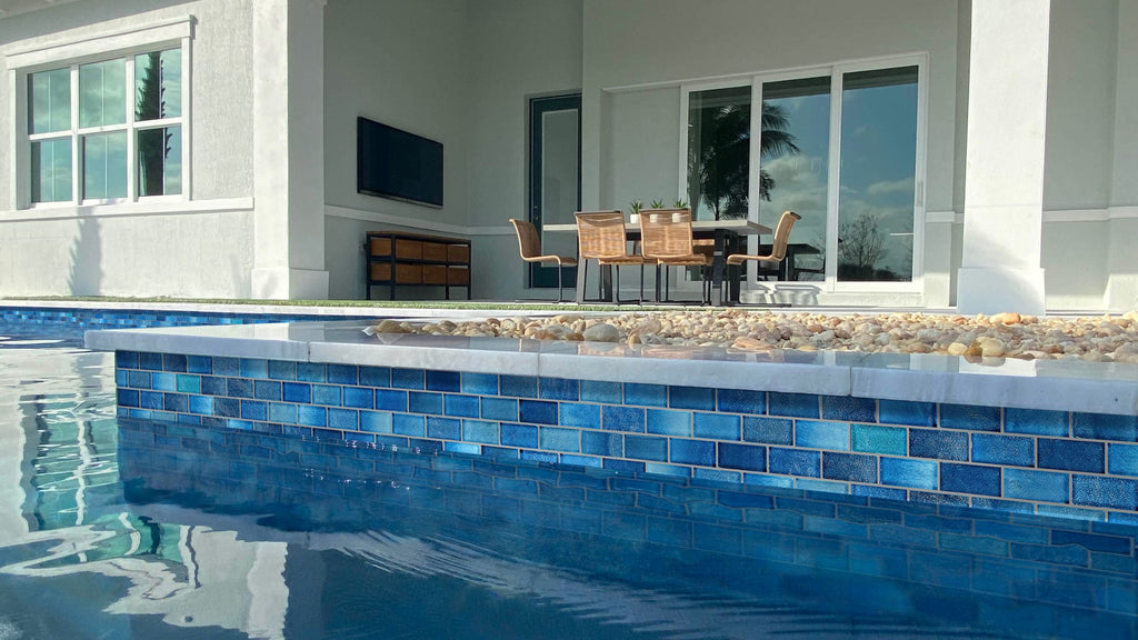 Blue subway tile in a pool waterline.