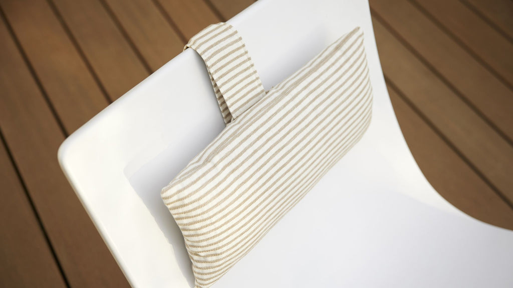 A closeup shot of a tan striped cushion installed on an autograph chair.