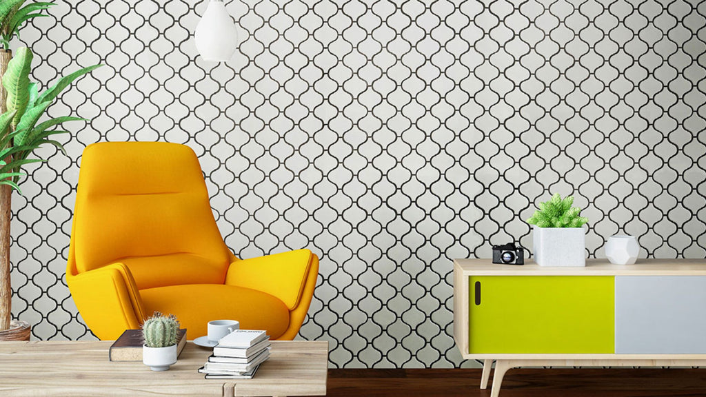 White arabesque porcelain tile with dark colored grout in a feature wall inside a living room. The furniture features bright vivid mustard and lime green colors which pop out beautifully against the clean simple color of the tile.