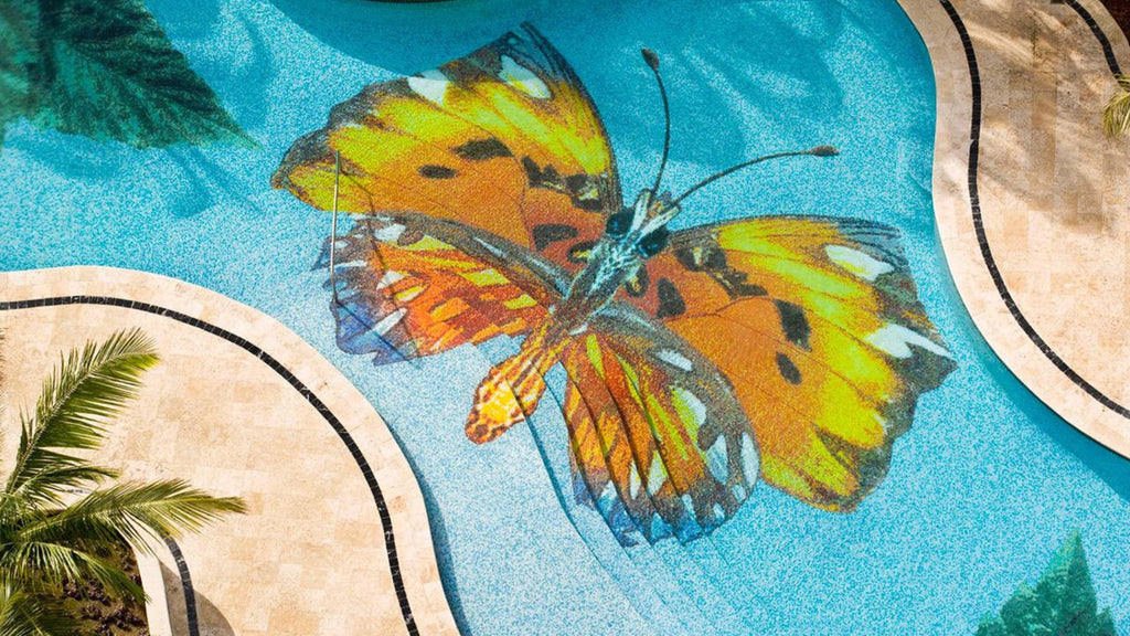 A large butterfly artistic mural as a focal point inside a large commercial pool.
