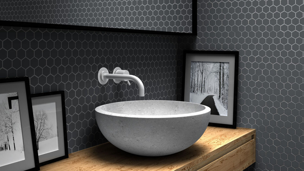 Dark gray hexagon tile in a modern bathroom backsplash.