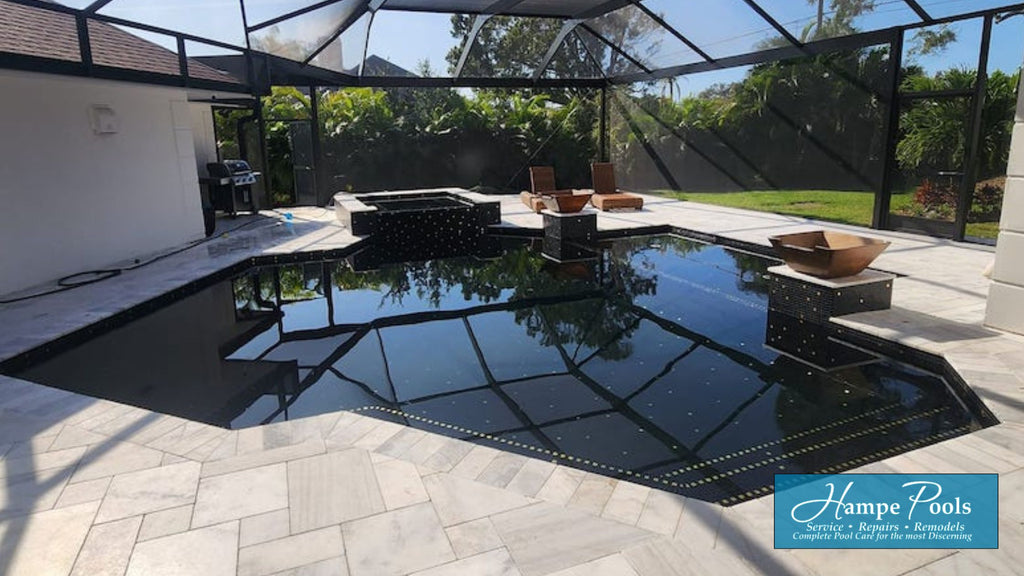 a luxury all glass tile pool featuring black glass and 24k gold tiles.