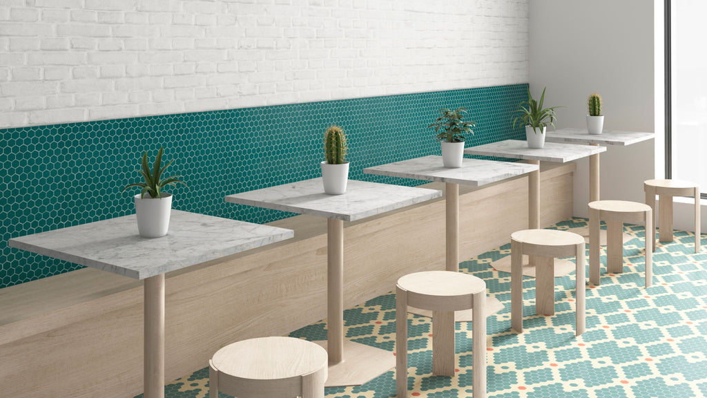 Green hexagon tile from the Candy collection by Vidrepur. It's installed across a wall in a restaurant behind booth seating.