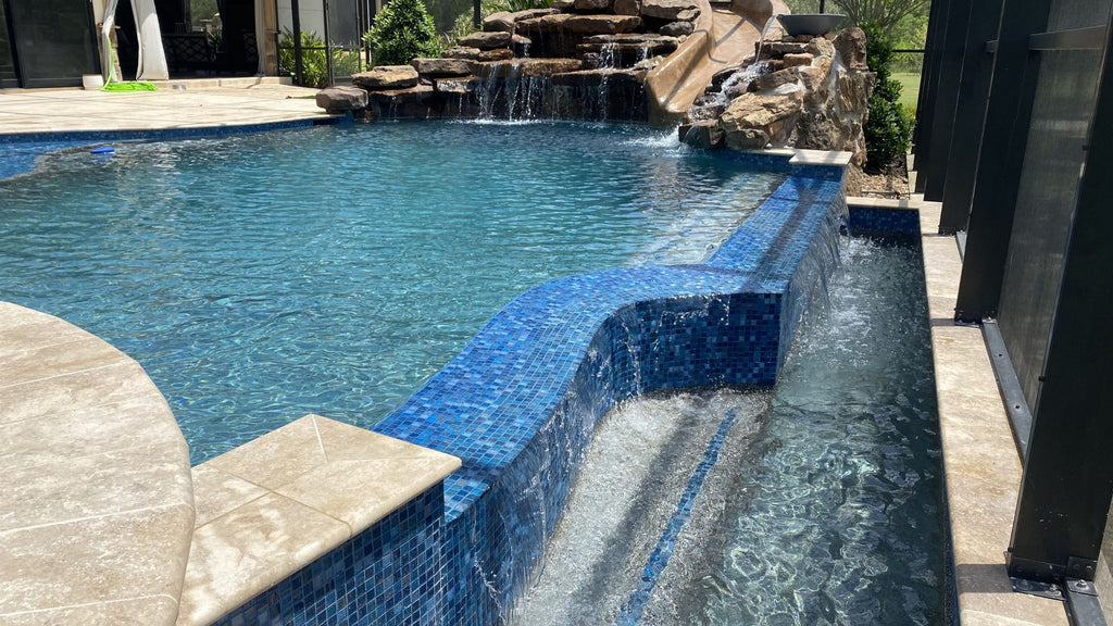 small, blue glass tiles used in a feature wall in a pool