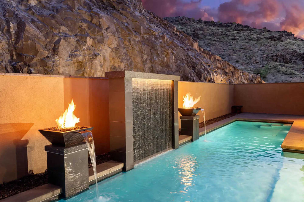fire and water combination bowl running to a luxury pool with a mountainous backdrop.