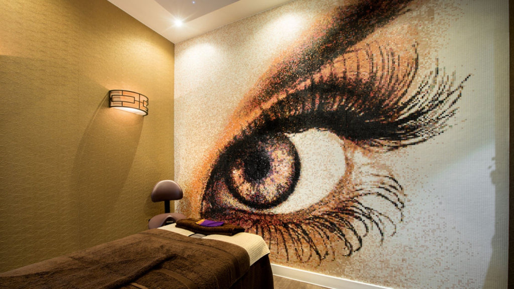 A large glass pixel art mosaic wall mural of a large beautiful eye with exaggerated eyelashes