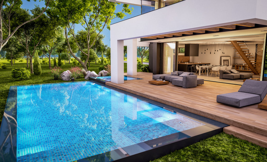 A modern, all-glass tile pool next to a beautiful, modern home.