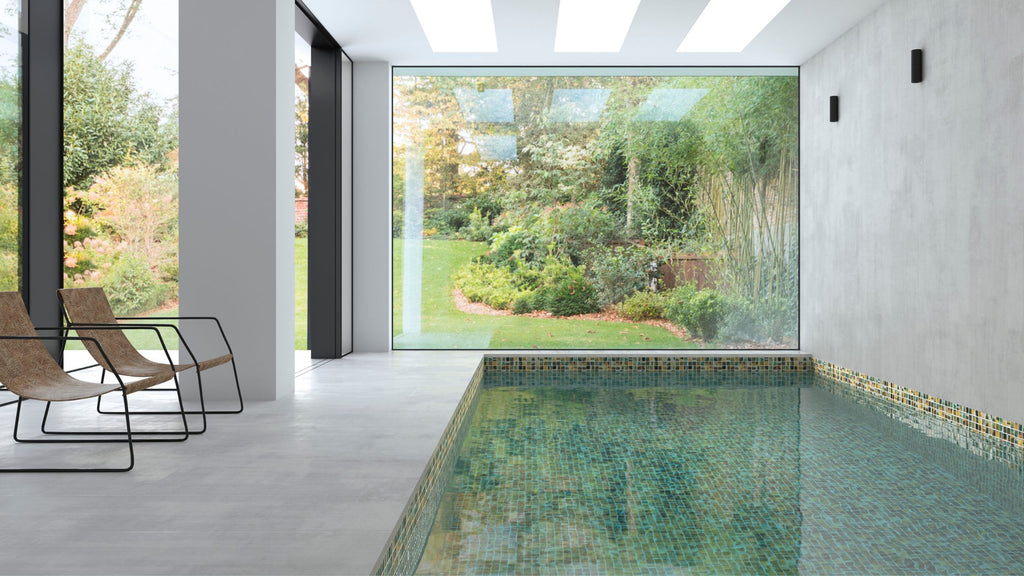 Green and gold tile from the Estellar series in an indoor, all glass tile pool.