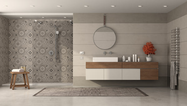 Photo of a patterned shower wall and accent wall next to a modern, sink and wash area. 