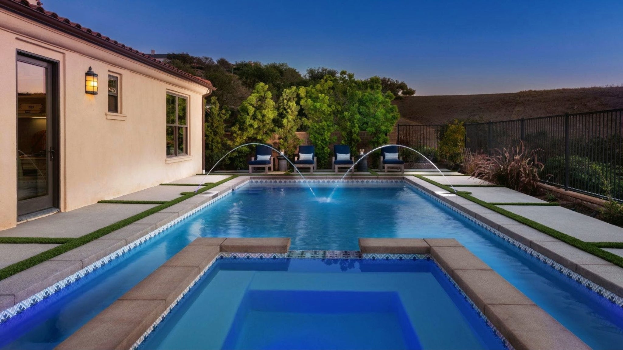 patterned porcelain waterline tile in a new, beautifully designed pool with fountains