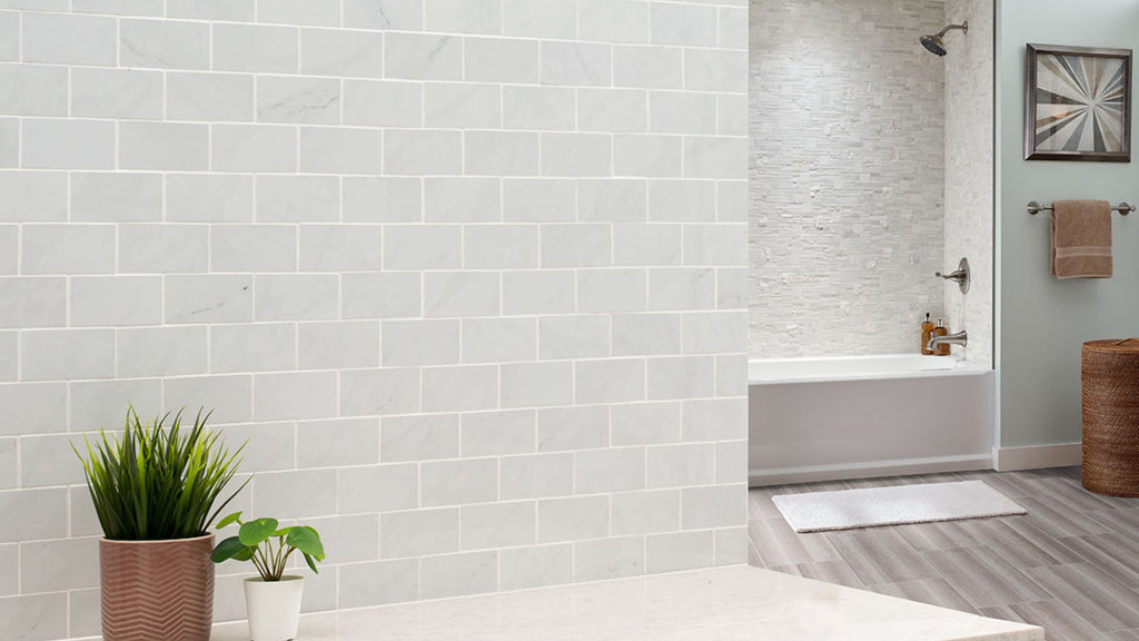 Subway Tile in a light gray and crema color adorning the walls in a very welcoming, airy bathroom.