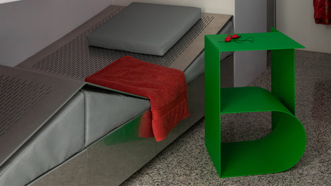 A lounge bed with a Glyph Side Table Beta beside it.