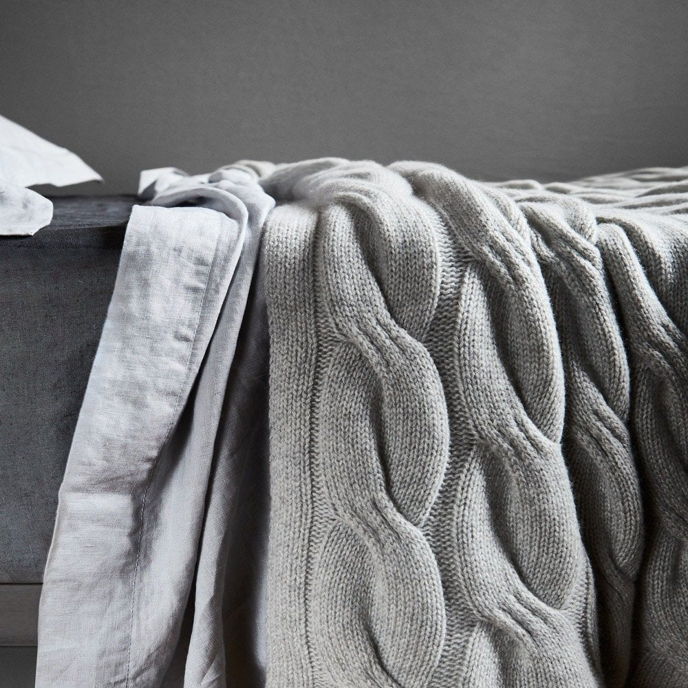 Bemboka grey cashmere chunky cable knit throw on bed