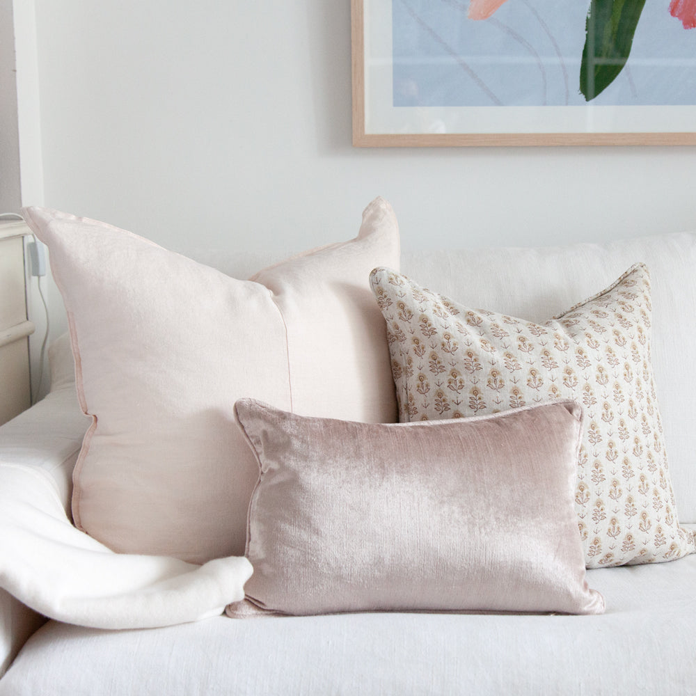 small pink velvet cushion styled with pink printed cushions