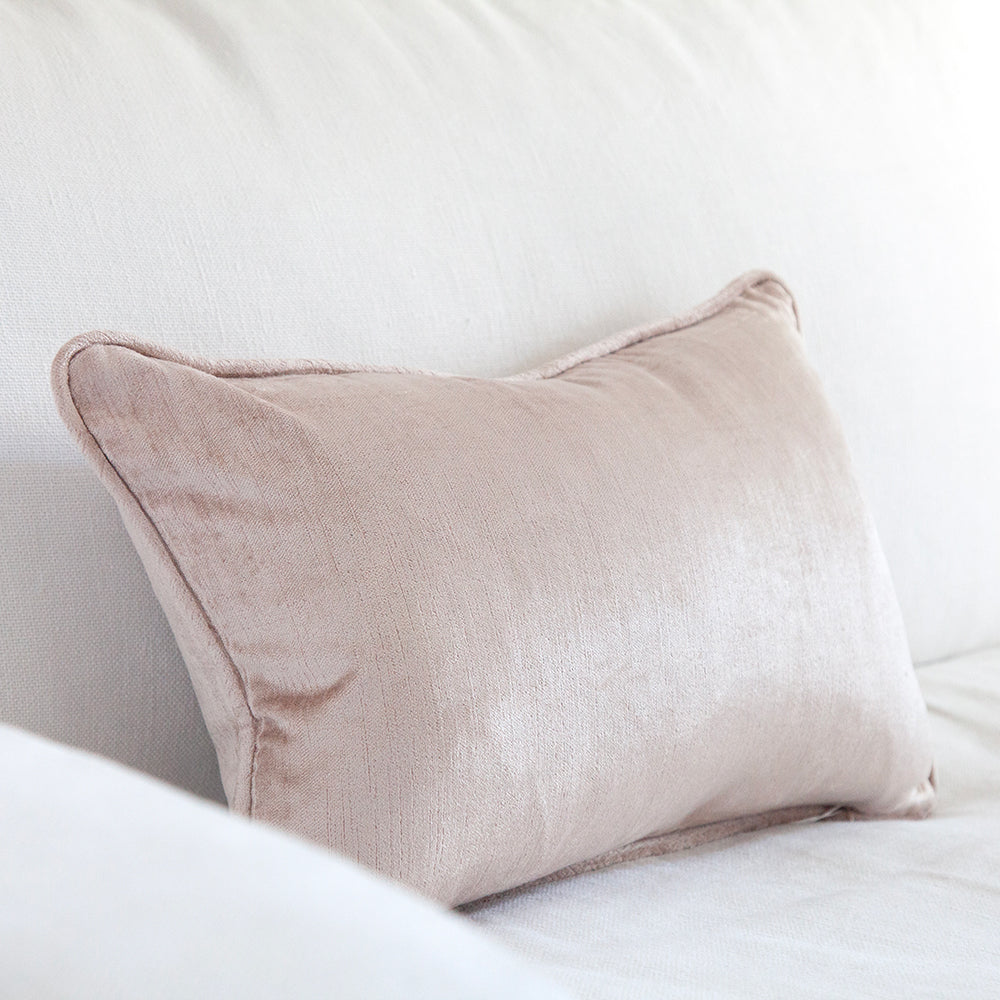 small dusty pink velvet cushion on white sofa