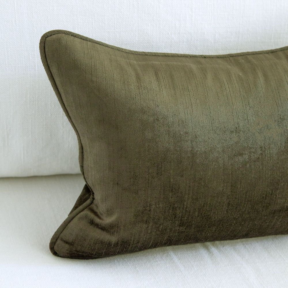 close up of small dark green velvet cushion