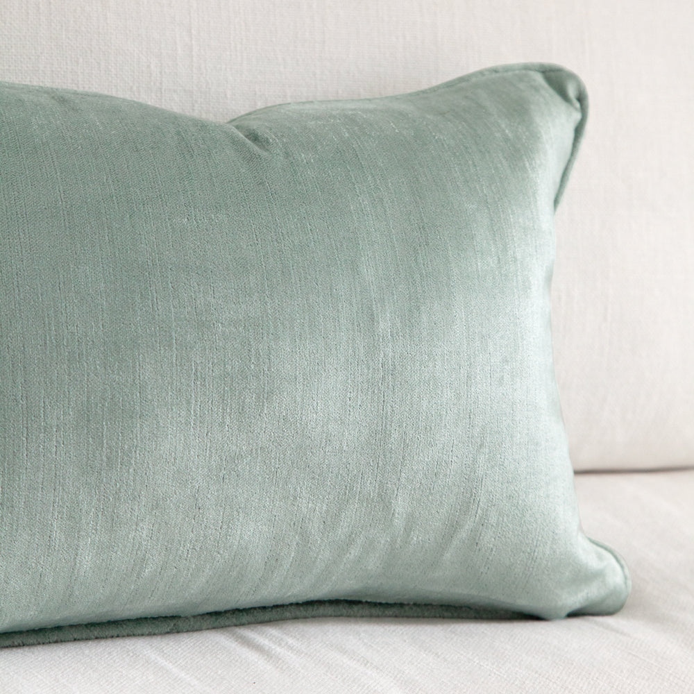 close up of small aqua blue velvet cushion