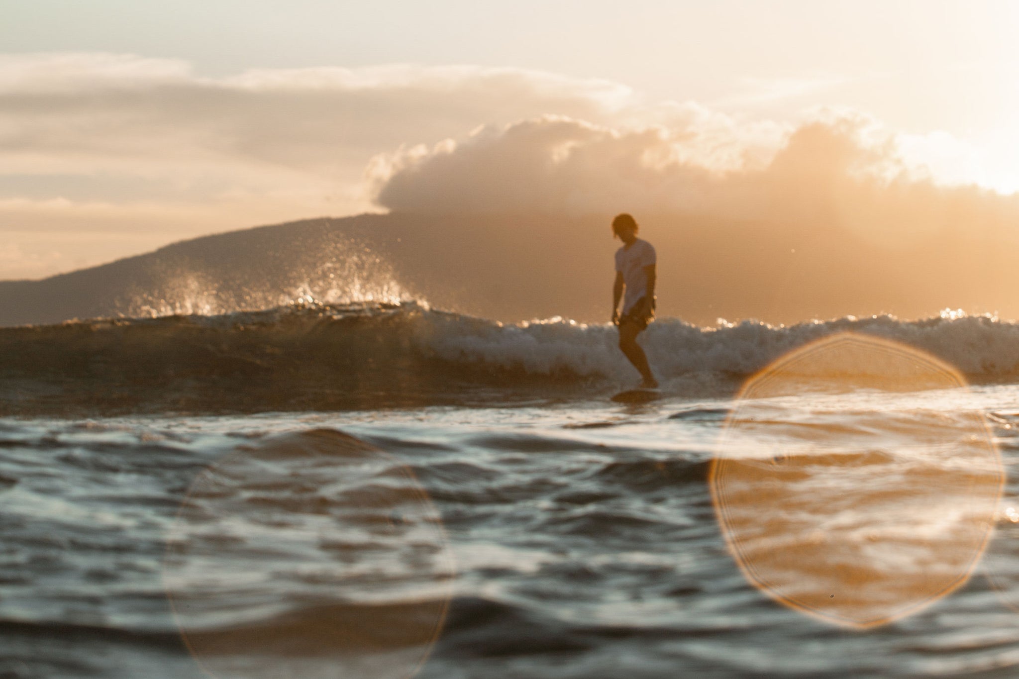 Surfing in Hawaii during sunset