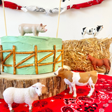 toy animals on farm themed cake