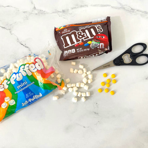 marshmallows and M&M's to make daisies for cake decorations