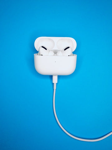 AirPod Pros charging on a blue background