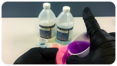 Pouring a fluorescent purple resin mixture into a silicone mold