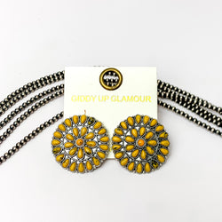 Silver Tone Circle Cluster Stud Earrings with Yellow Stones. Pictured on a white background with beads through the background.