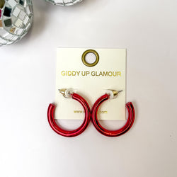 Light Up Small Neon Hoop Earrings In Red. Pictued on a white background with disco balls in the top left corner.