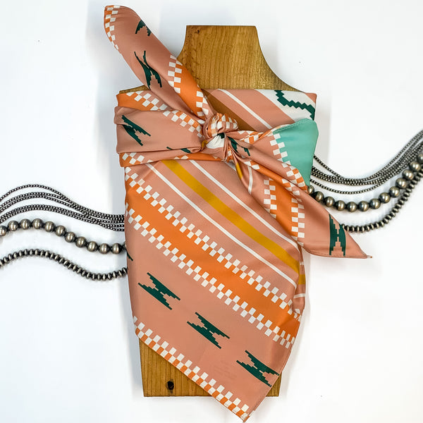 Solid colored scarf in Santa Fe Trail. Scarf is tied around a wooden piece. The scarf and piece of wood is pictured on a white background with Navajo jewelry spread out around it.
