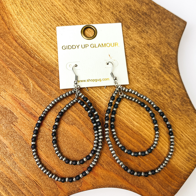 Beaded Double Drop Earrings in Silver Tone and Black. Pictured on wood piece.