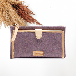 Purple, sparkle wallet with light tan outline. This wallet is pictured on a white background with tan and brown pompous grass in the corner. 