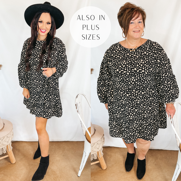Models are wearing a black long sleeve dress that has a white spotted print. Size small model is wearing black booties and a black hat. Plus size model is wearing black booties and gold jewelry.