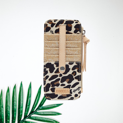 A leopard print card organizing wallet with gold glitter contrast. Pictured on white background with a palm leaf.