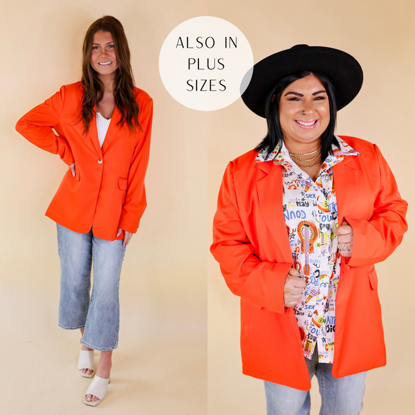 Model is wearing a bright orange blazer with long sleeves and a collared neckline. Model has it paired with a mix print button up shirt, cropped jeans, black mules, and a black hat.