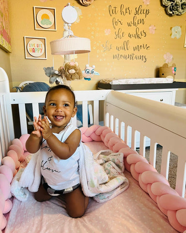 Baby playing in crib