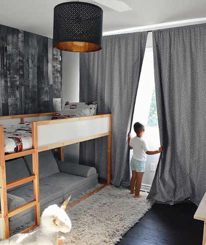 boy looking out the window in bedroom