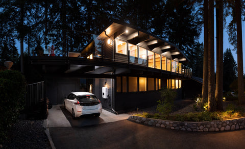 house and garage with lights on