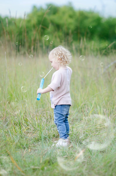 Toddler playing with bubbles