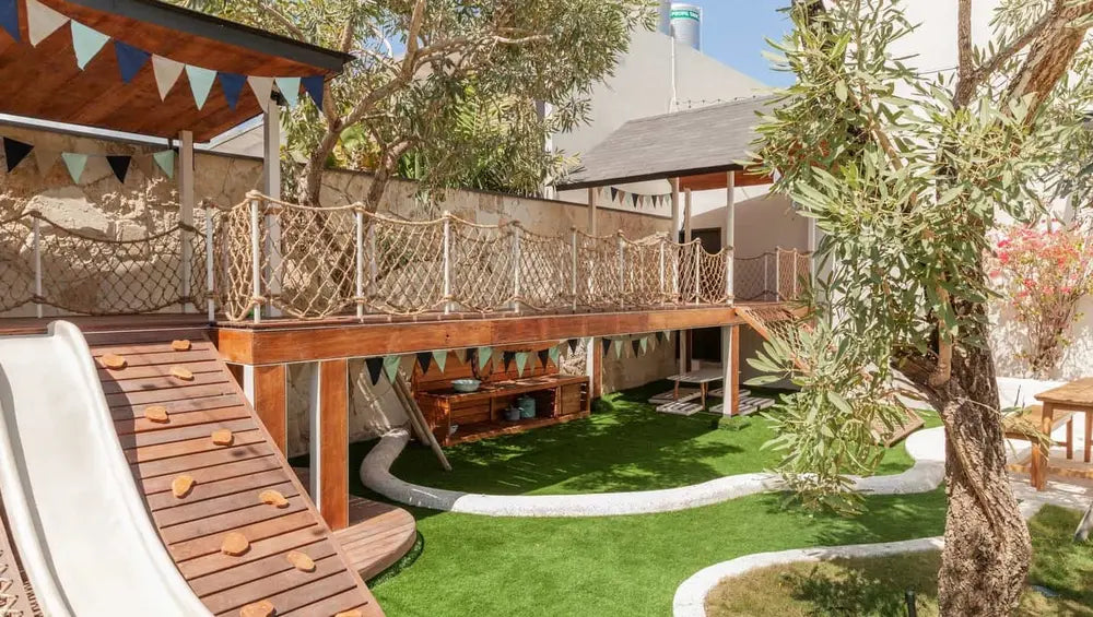 The children's playground at the Milk & Madu Cafe featuring undercover areas, slide and climbing ramp.