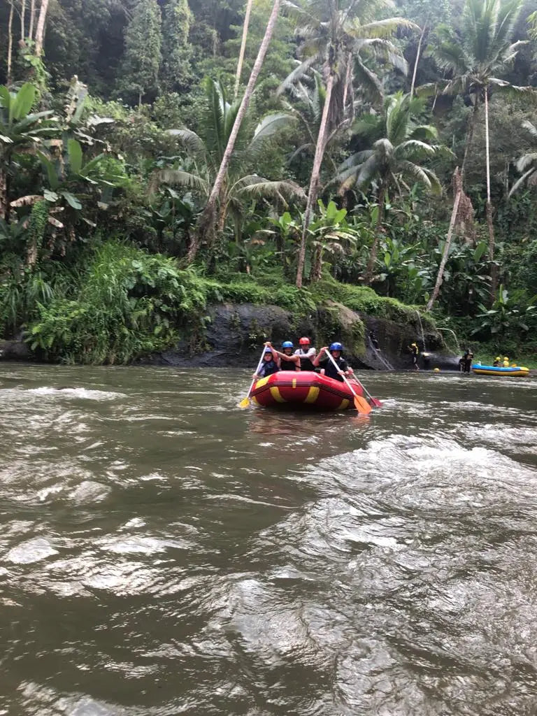 A family battles the current in a raft on the Ayung River in Bali.” 