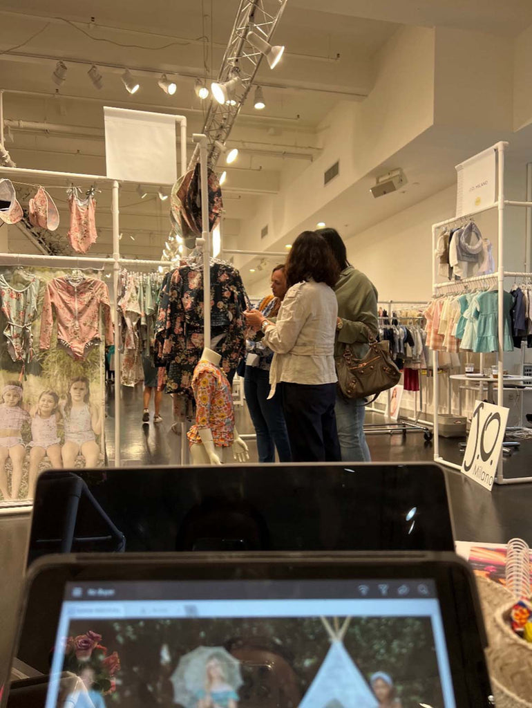 Curious Playtime Tradeshow attendees browse Olga Valentine’s display of fashionable kids swimwear.