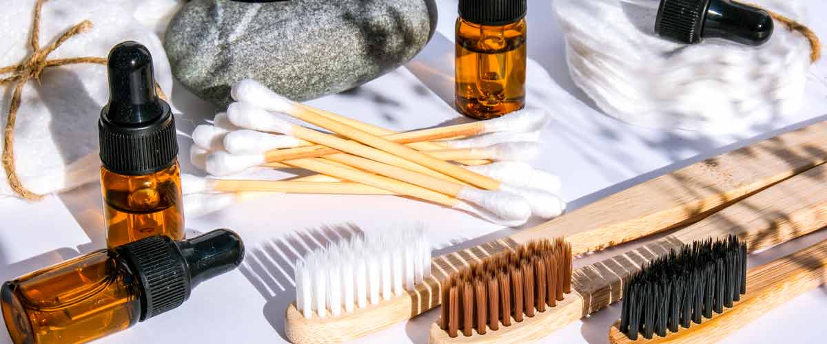 bamboo toothbrushes next to essential oil bottles