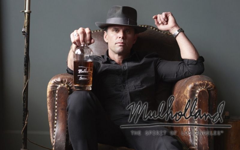 Goggins posing with a bottle of Mulholland Whiskey - Image by whiskyadvocate.com