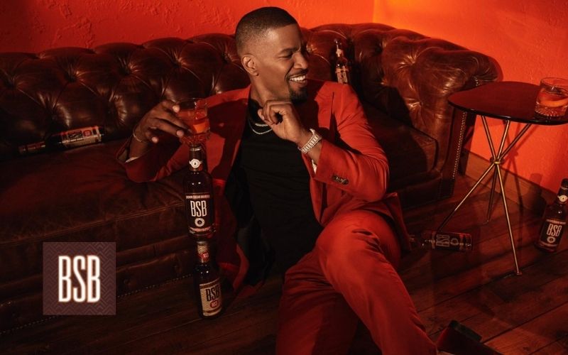 Foxx posing with a bottle of BSB bourbon