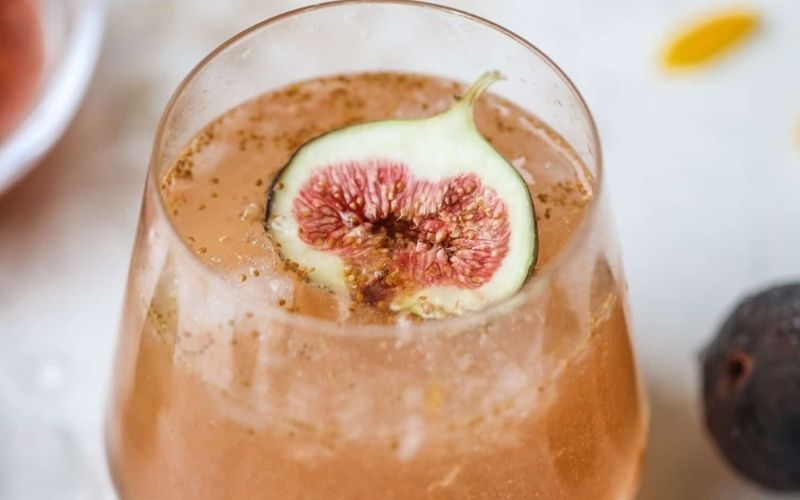 A glass of Brown Sugar Fig Bubbly cocktail