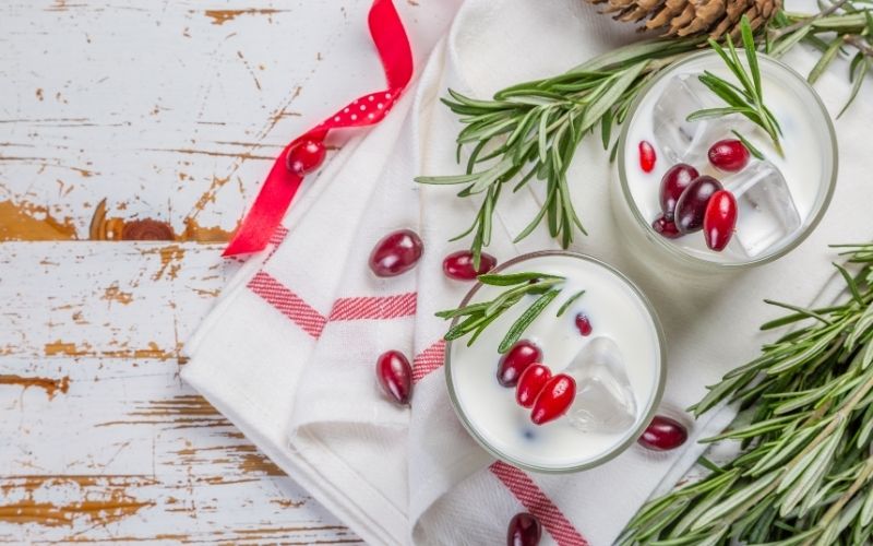 Glasses of White Christmas Margarita Punch with Cranberries and Rosemary